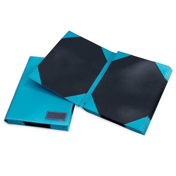 Open custom restaurant menu cover in pink fabric with tan leather corners and screwpost binding