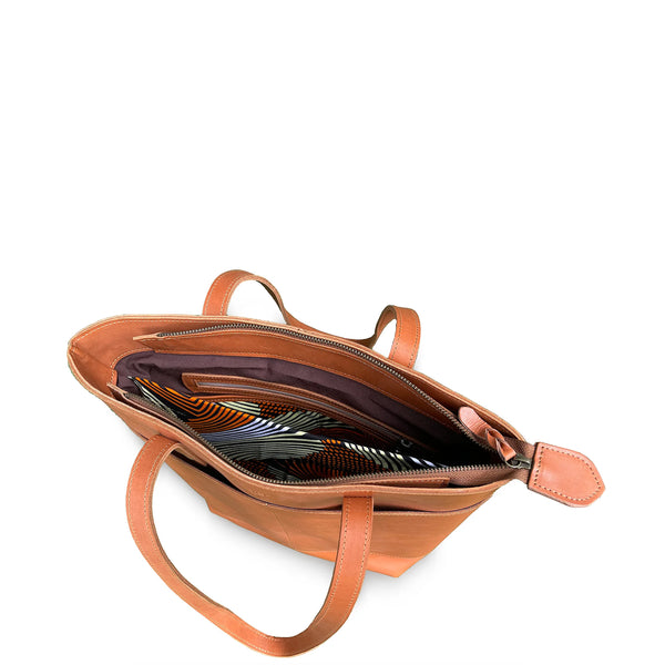 Brown leather handbag with open front pocket on a white background