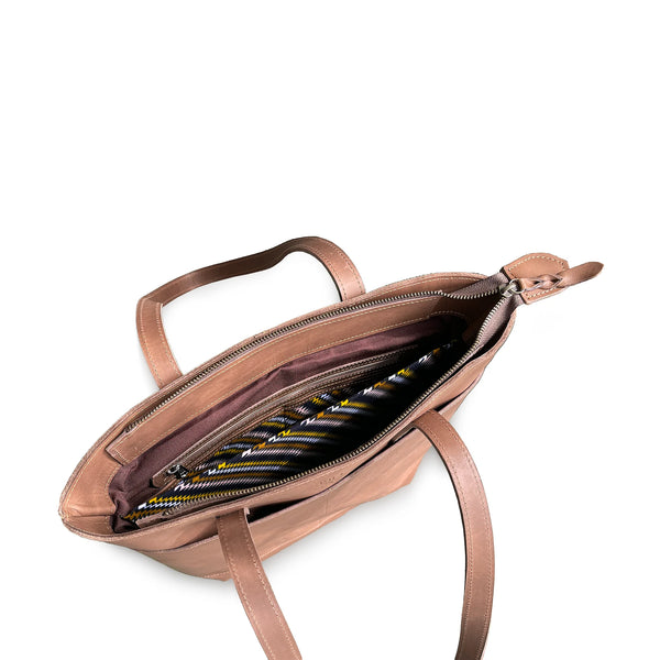 Open brown leather handbag with striped interior on a white background