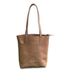 Brown leather tote bag on a white background