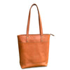 Brown leather tote bag on a white background