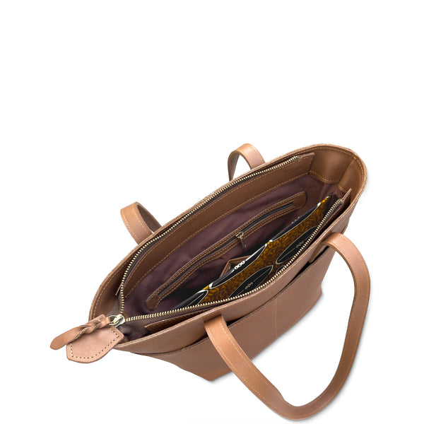 Open tan leather handbag with interior details on a white background