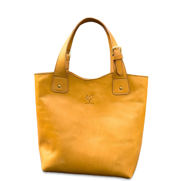 Tan leather tote bag with a visible brand logo on a white background