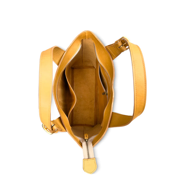 Tan handbag with a white background