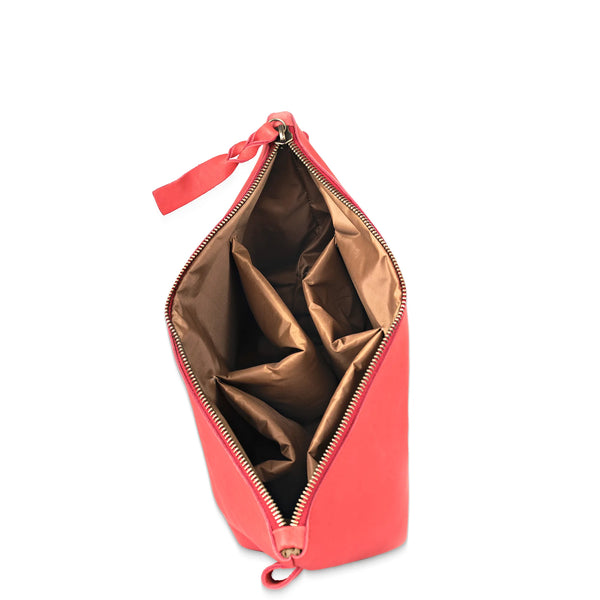 Open coral pink pouch with a gold interior on a white background