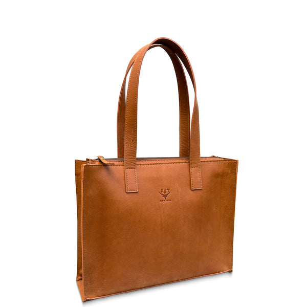 Brown leather tote bag with a visible brand logo on a white background