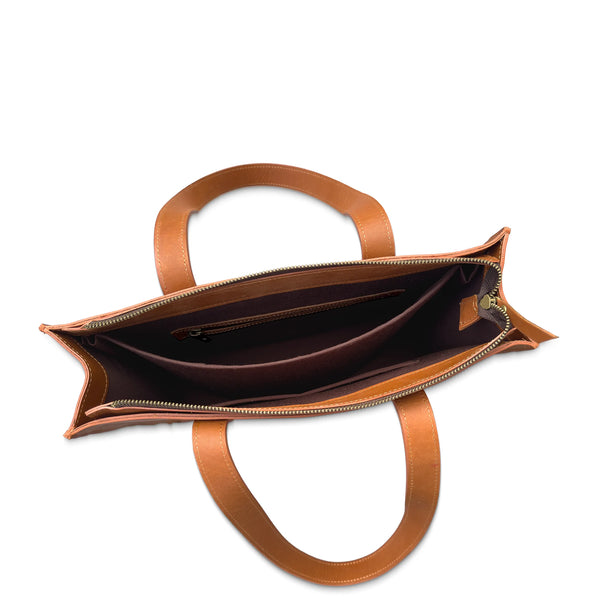 Brown leather handbag with open top on a white background