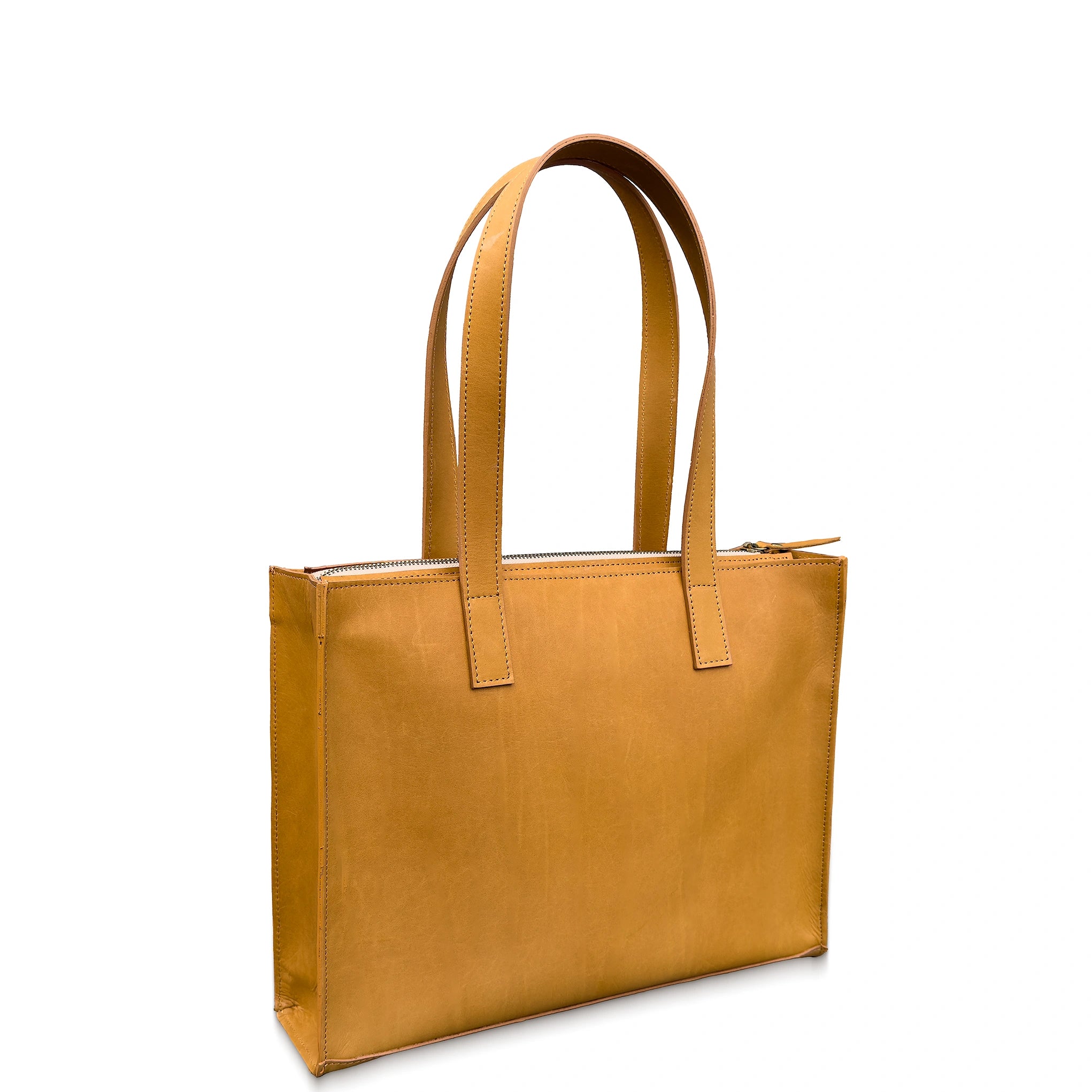 Tan leather tote bag on a white background