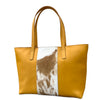 Tan tote bag with cowhide pattern on a white background