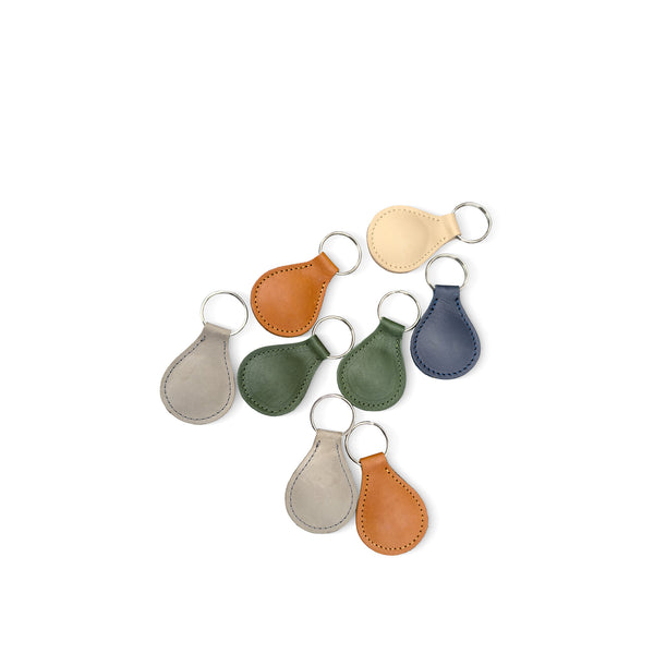 Set of seven leather keychains in various colors on a white background
