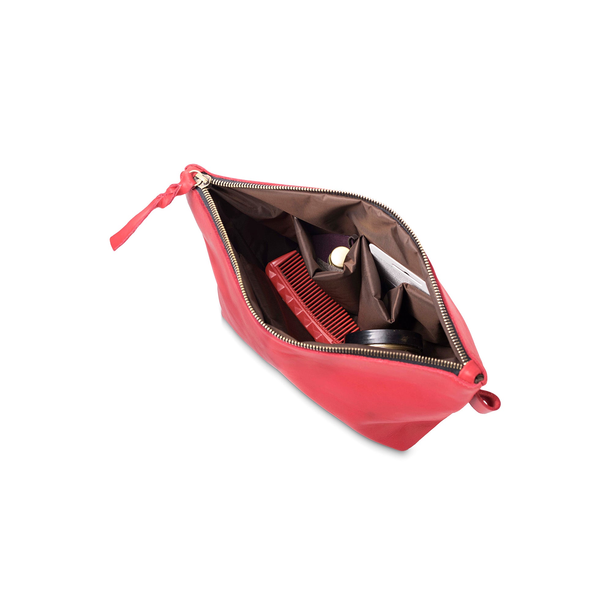 Red makeup bag with a comb and mirror on a white background