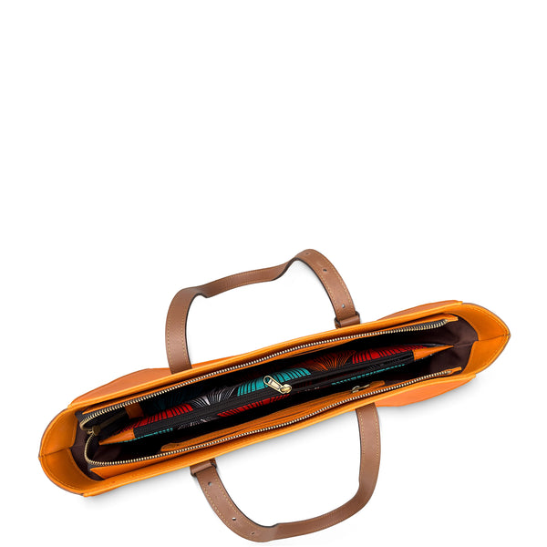 Orange leather bag with brown handles on a white background