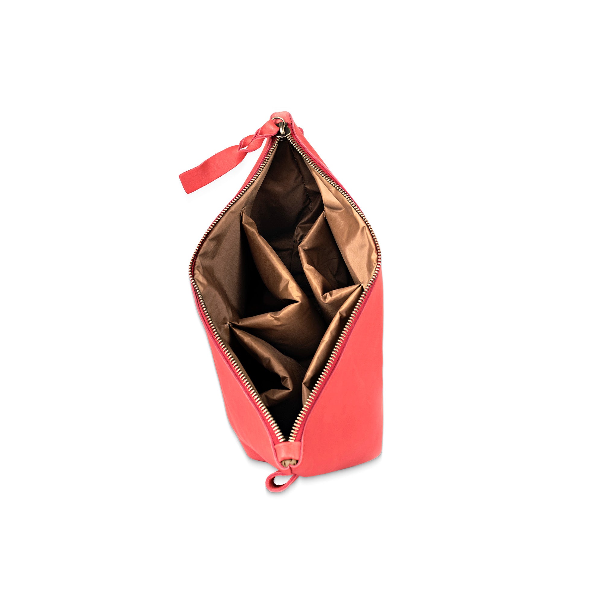 Open red toiletry bag with a white background