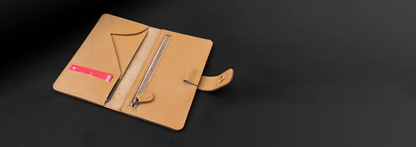 Brown leather case with a pen on a black background