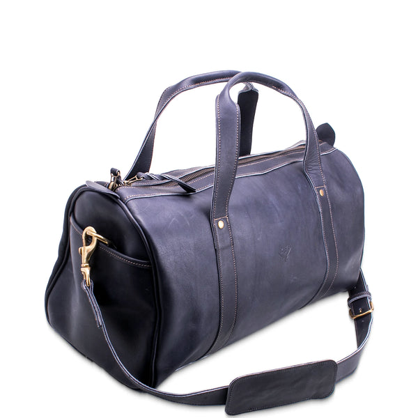 Blue leather duffel bag with gold zipper on a white background