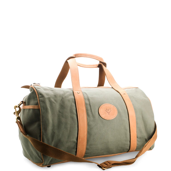 Green duffel bag with brown leather straps on a white background