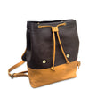 Two-tone leather backpack with drawstring closure, dark brown body and tan base, on white background.