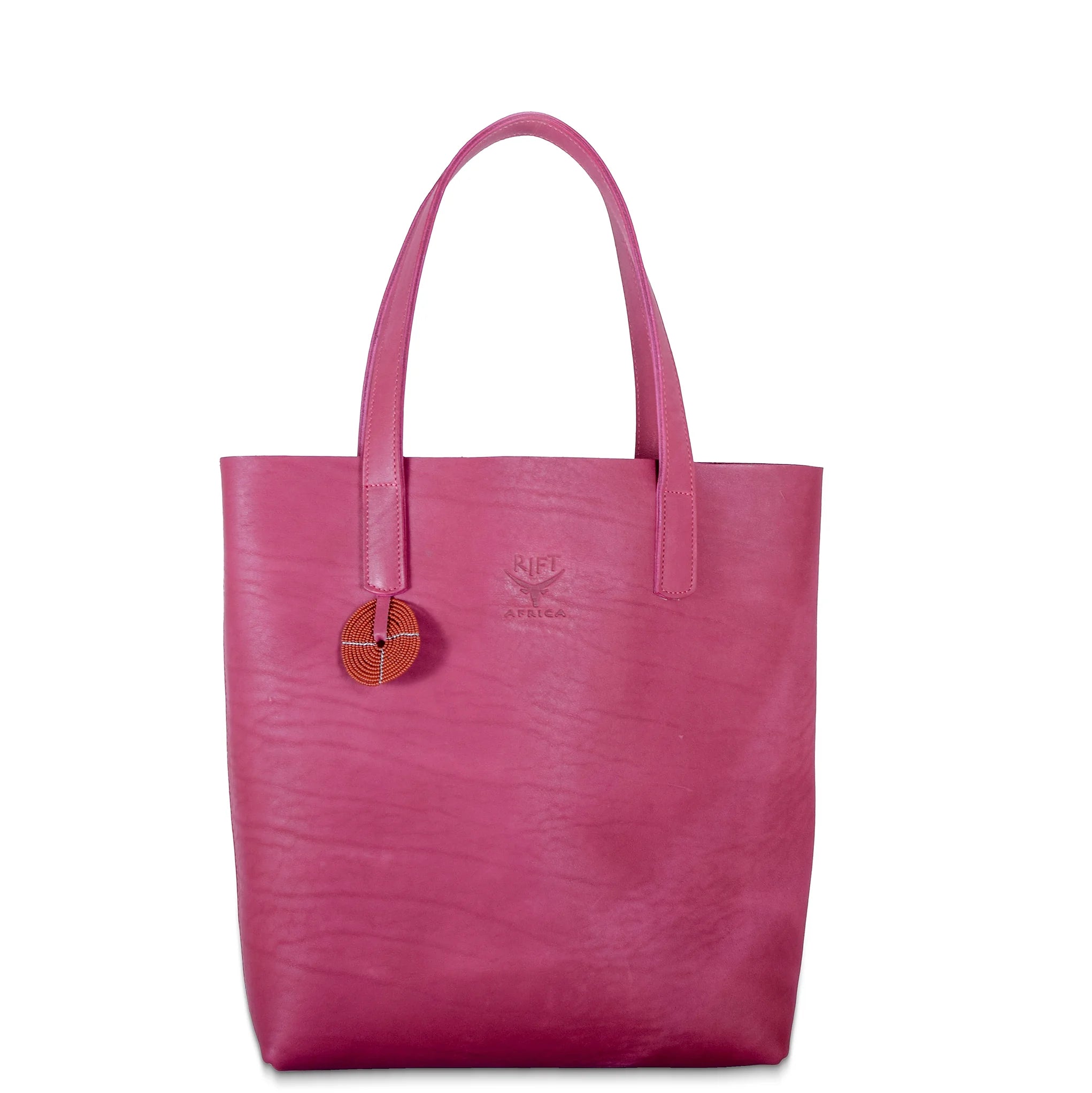 Pink leather tote bag with a circular emblem on a white background