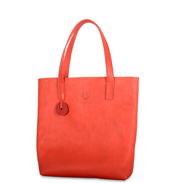 Red leather tote bag with a visible brand logo on a white background