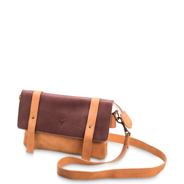 Brown and tan leather crossbody bag on a white background