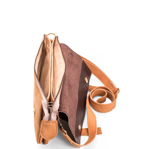 Brown leather crossbody bag with a strap on a white background