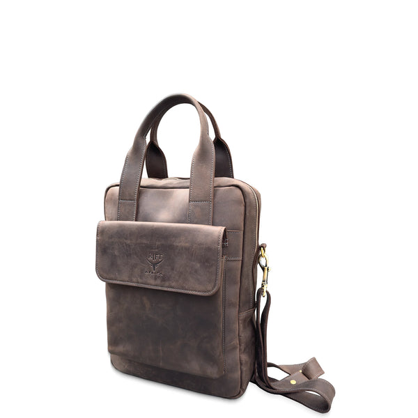Brown leather bag with a shoulder strap on a white background