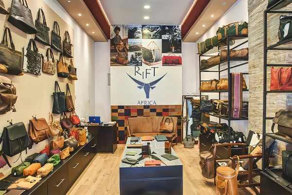 Interior of a store with various bags displayed on shelves and walls, featuring the brand 'Rift Africa'.