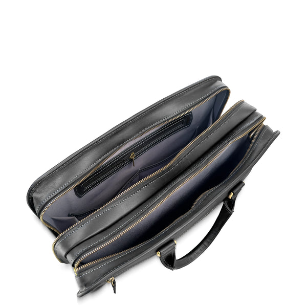 Black leather briefcase with gold zipper on a white background