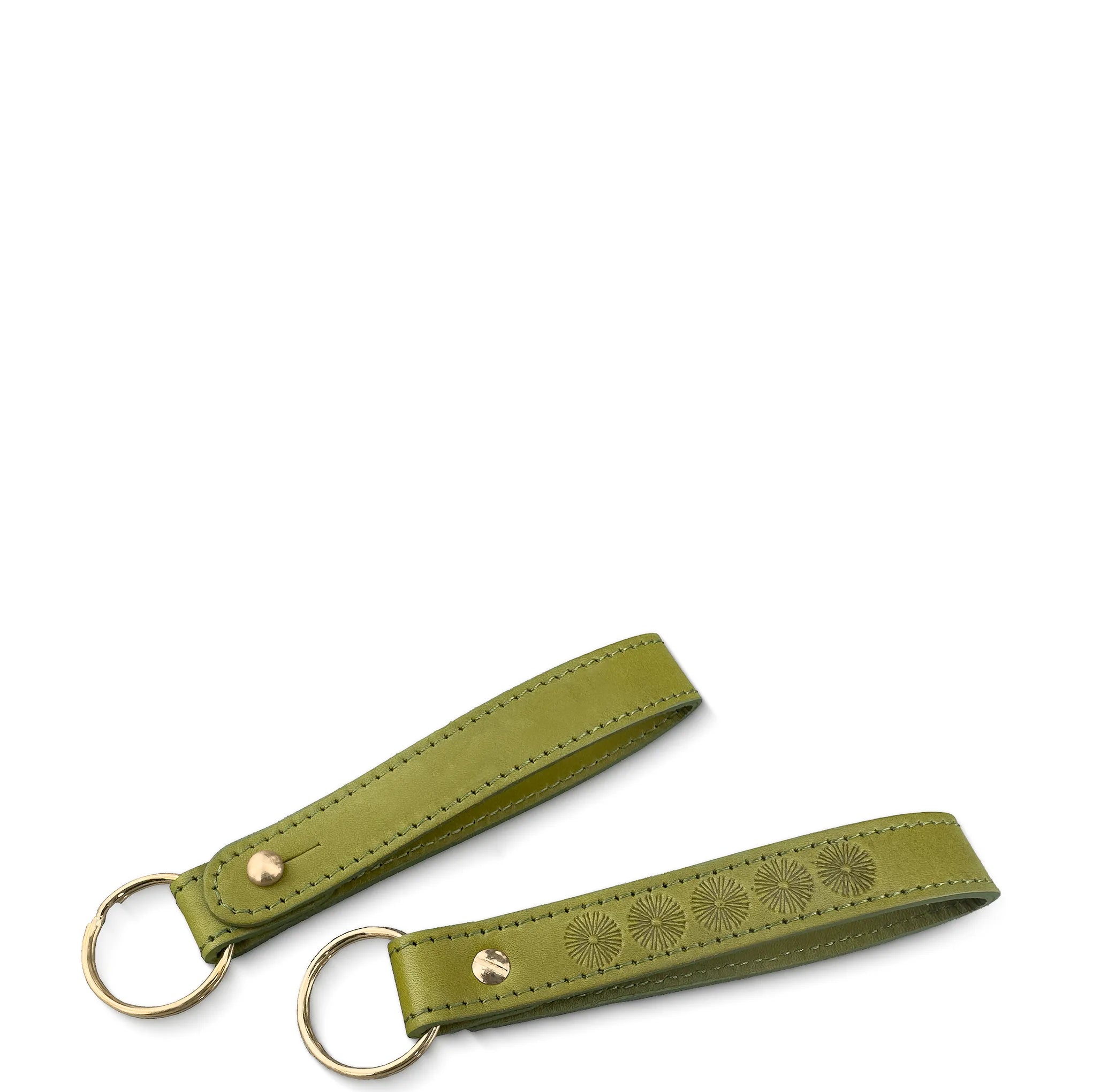 Green leather keychain with floral embossing on a white background