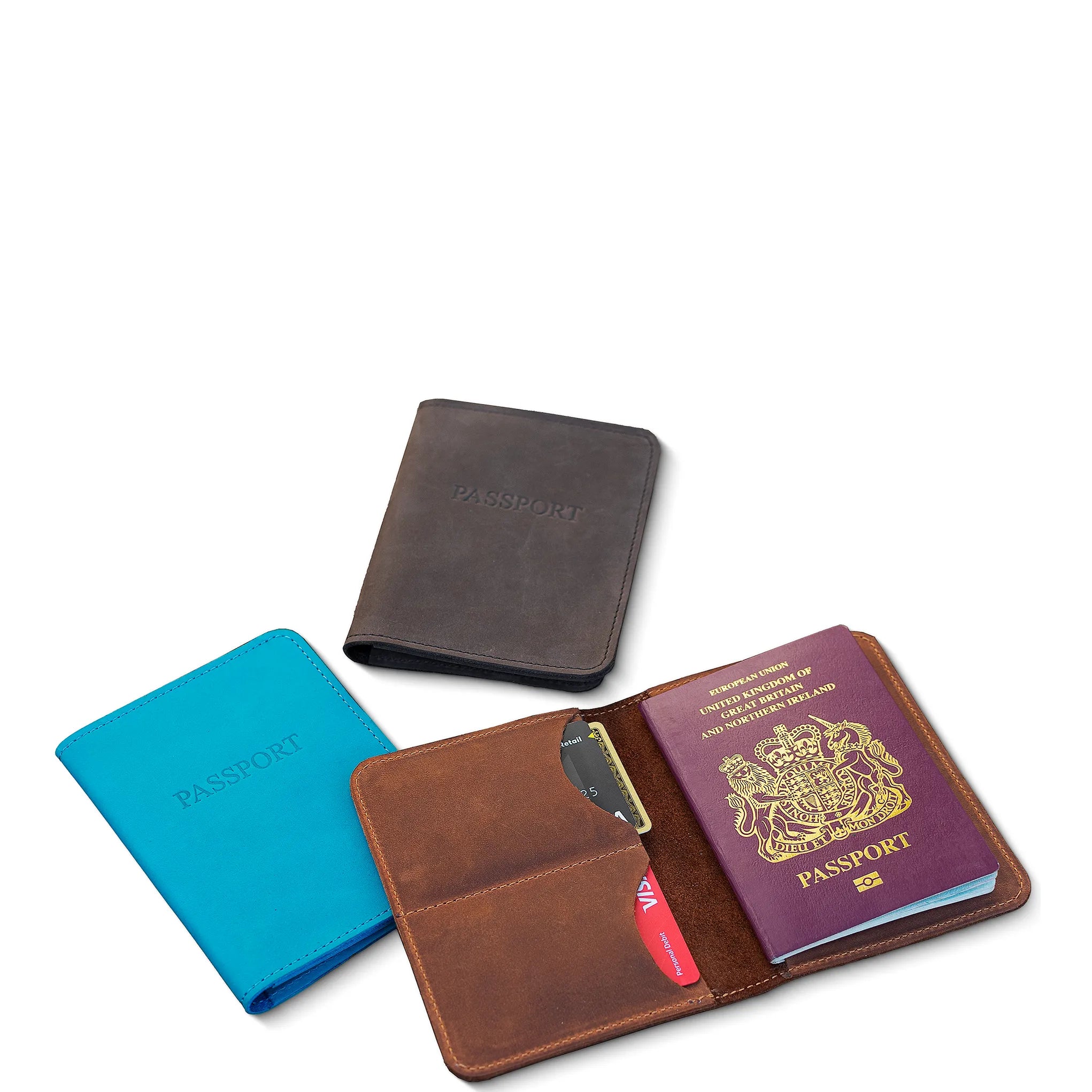 Collection of leather passport holders and a passport on a white background