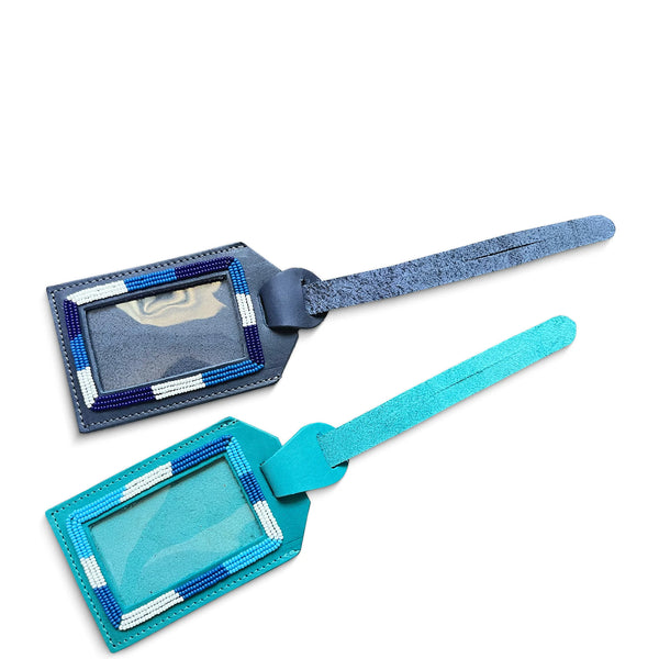 Two leather luggage tags, one blue and one turquoise, on a white background
