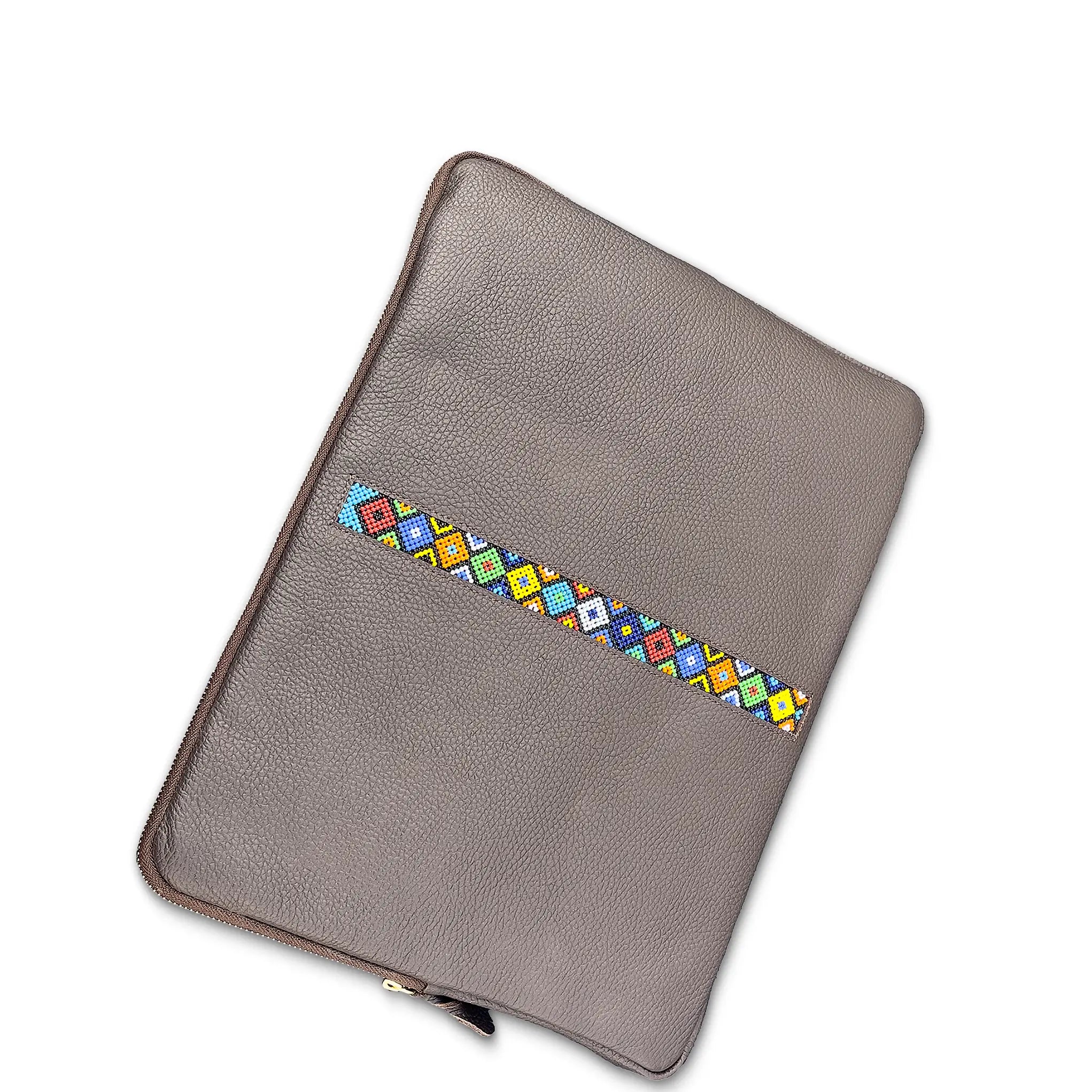 grey leather laptop sleeve with colorful geometric pattern on a white background