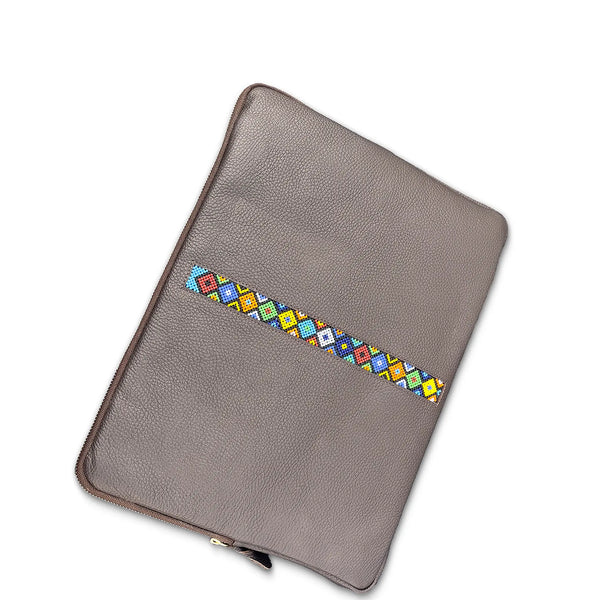 grey leather laptop sleeve with colorful geometric pattern on a white background