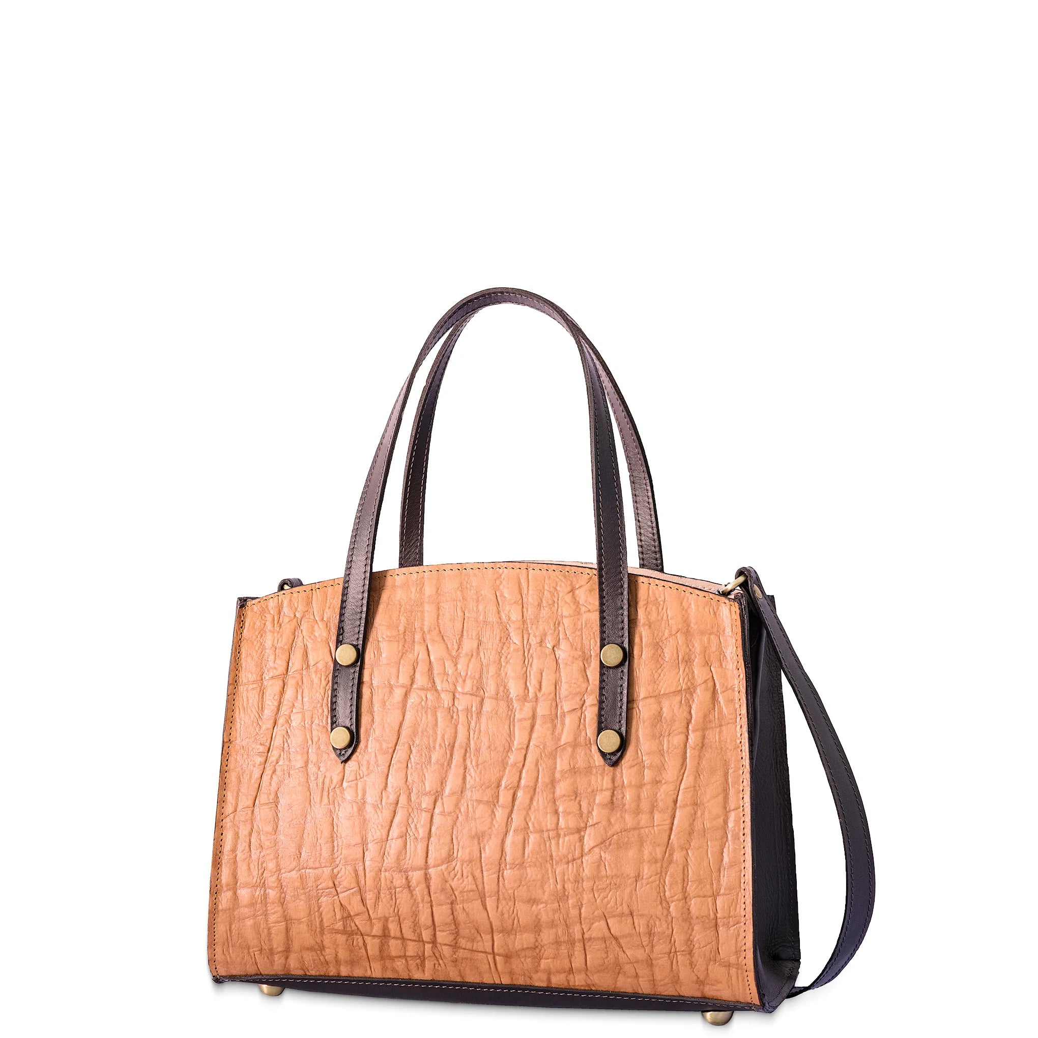 Tan handbag with brown handles and strap on a white background