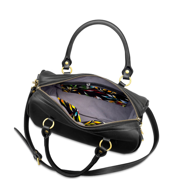 Black handbag with colorful interior lining on a white background