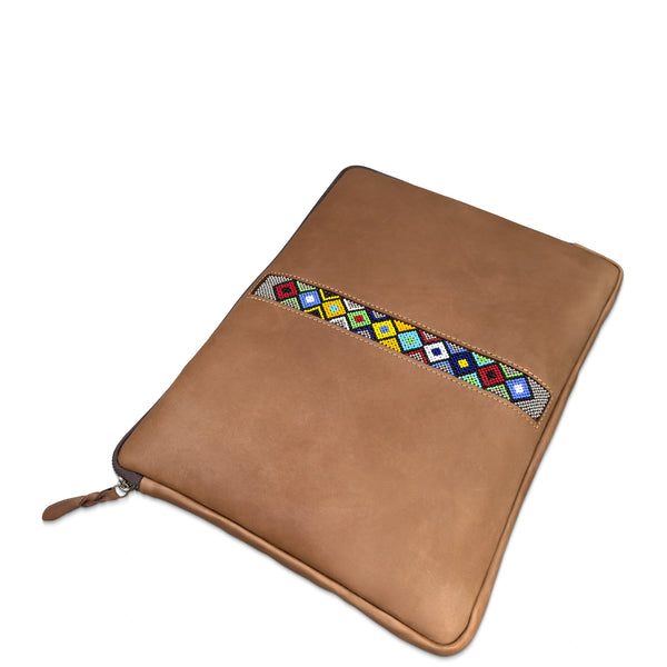 A tan leather zippered sleeve or pouch with a colorful geometric patterned accent strip across the front, shown on a plain white background.