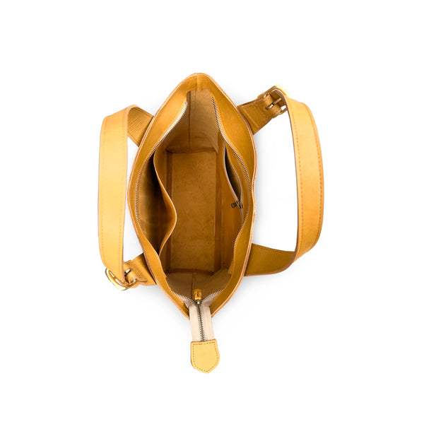 tan handbag with a shoulder strap on a white background