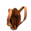 Brown leather handbag with a strap on a white background