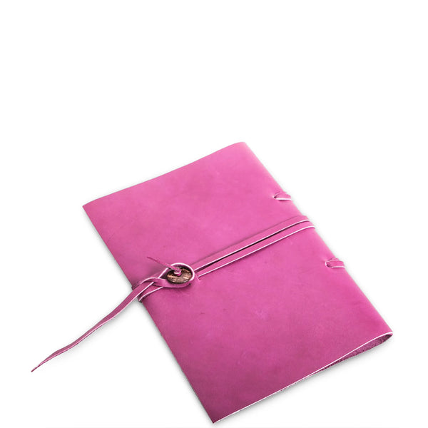 Pink notebook with a strap on a white background