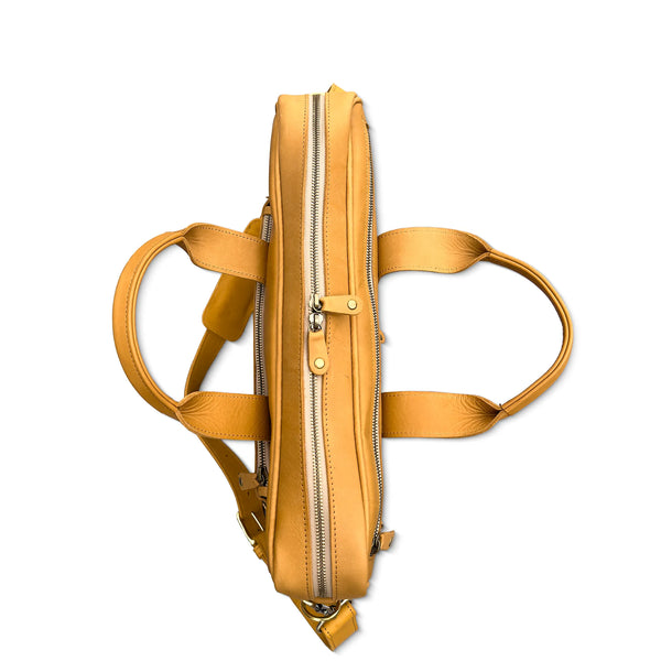 Tan briefcase with multiple zippers on a white background