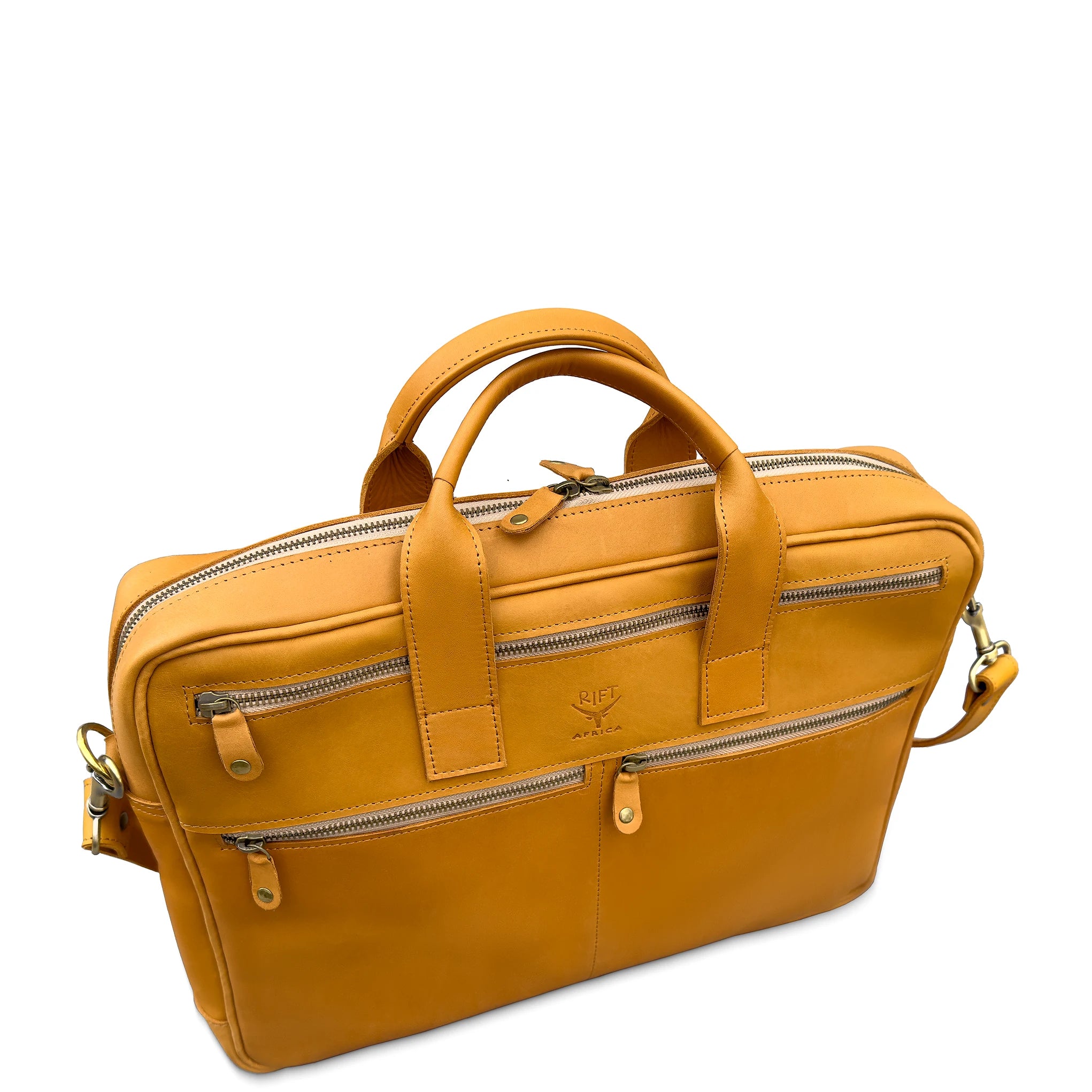 Angled view of tan leather briefcase with two front zipper compartments, top handles, and shoulder strap