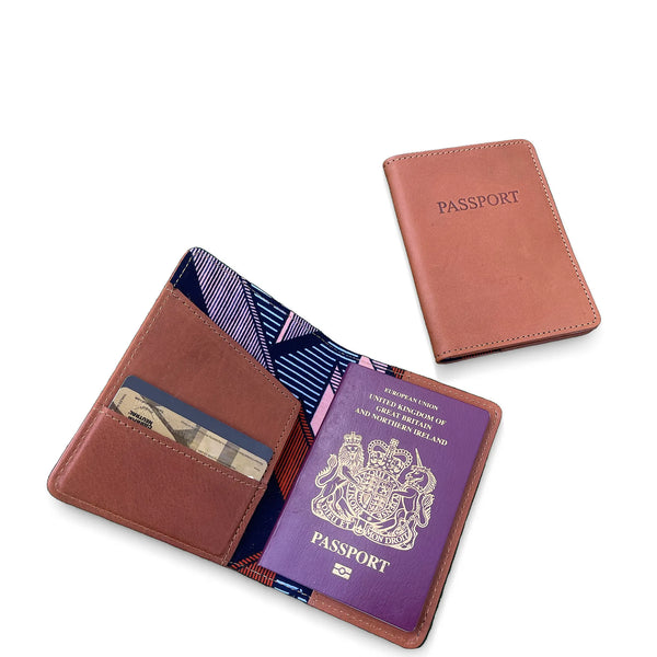 Brown leather passport holder with a purple passport on a white background