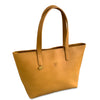 Tan leather tote bag with a visible brand logo on a white background