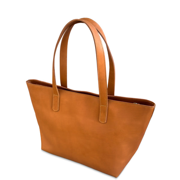 Brown leather tote bag on a white background