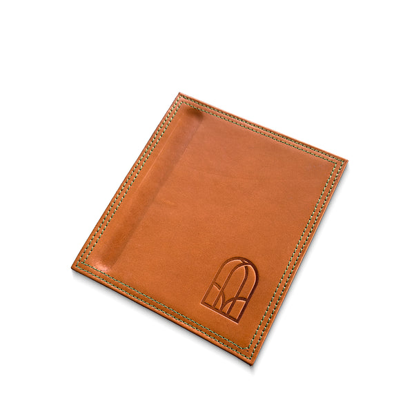 Brown leather note pad holder with stitching detail on a white background