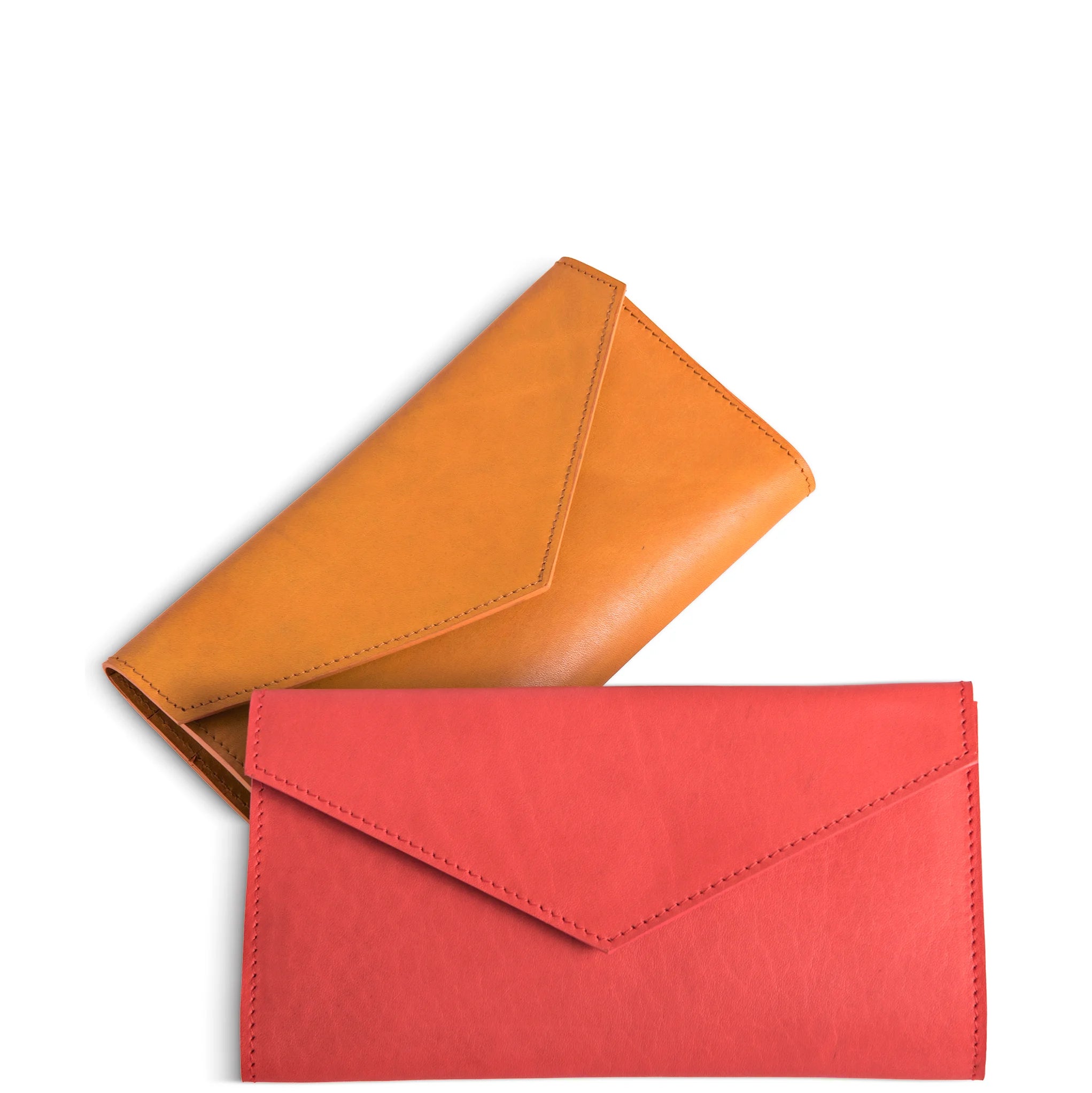 Two leather clutch bags, one orange and one red, on a white background