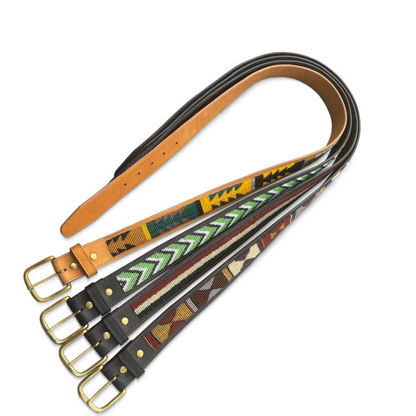 Set of leather belts with patterned straps on a white background