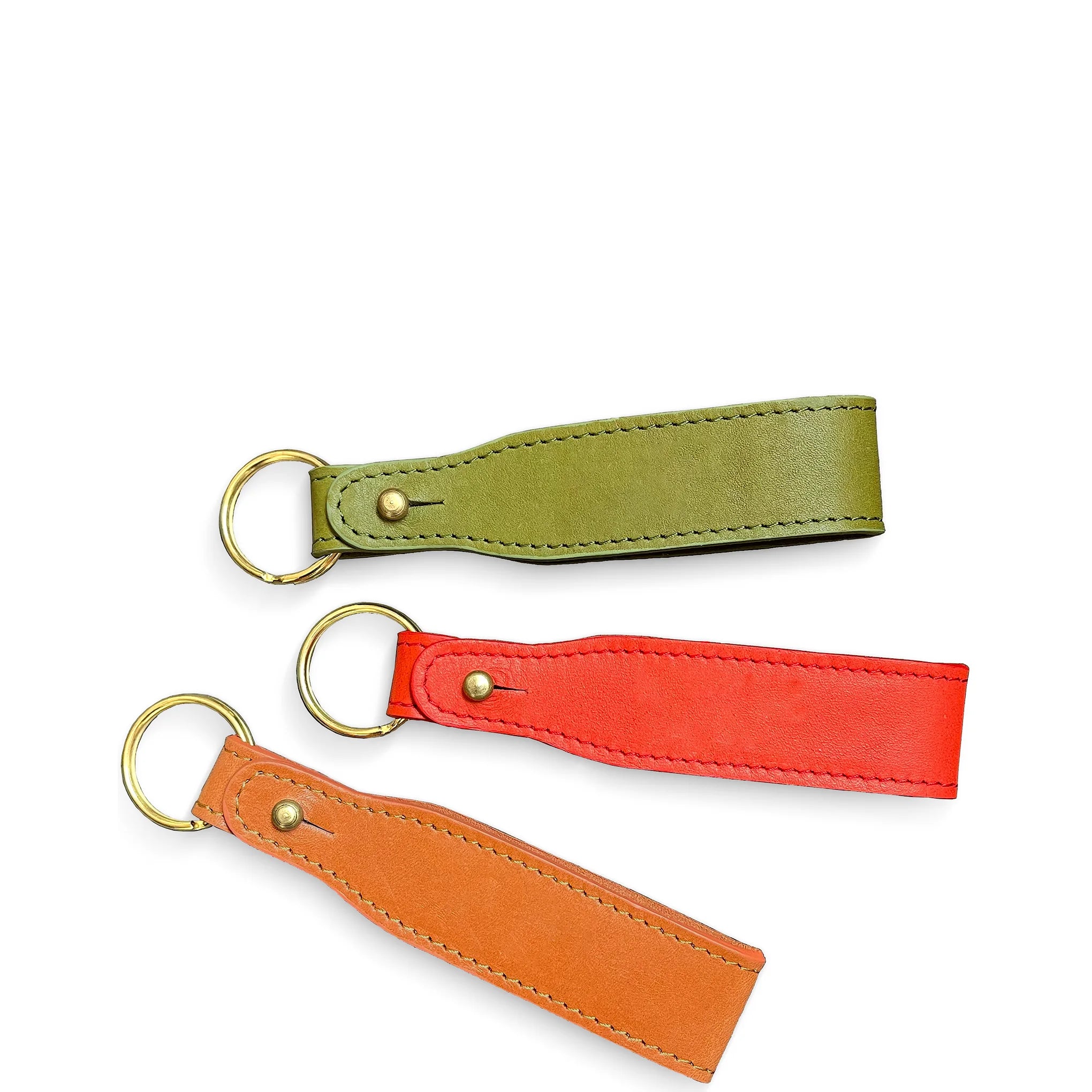 Three leather keychains in green, red, and orange on a white background