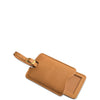 Brown leather luggage tag with gold accent on a white background