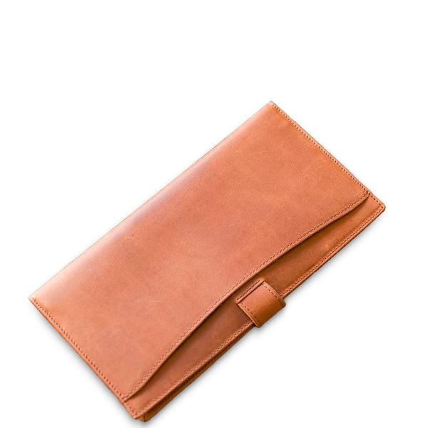 Brown leather clutch on a white background
